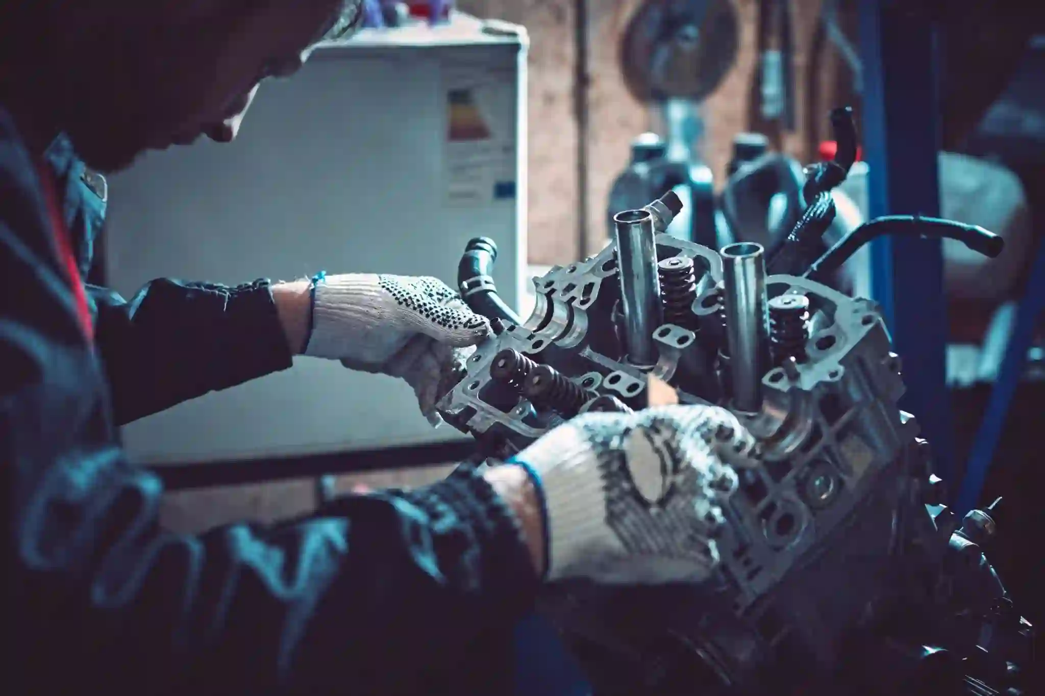 Engine Replacement Service By London Motor Sports A Man Inspecting Car Engine