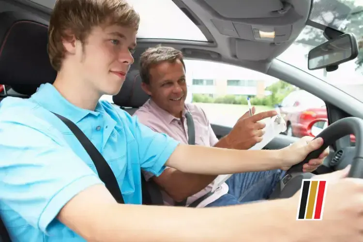 A Boy Wearing A Blue Shirt Is Driving A Car Under The Supervision Of An Old Man. This Scenario Is Quite Common For Those Learning To Drive In The Uk. If You'Re Wondering &Quot;How I Can Get The Driving License In The Uk,