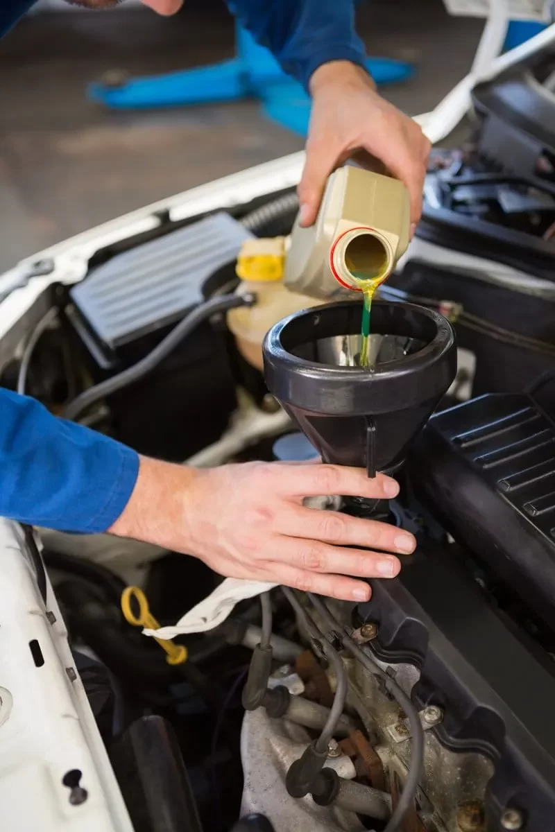 A Man Changing Car Engine Oil